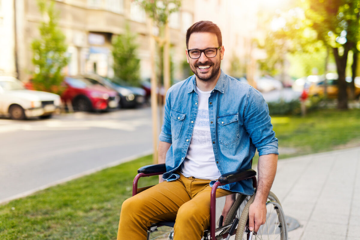 Portrait of handicapped young man in a wheelchair